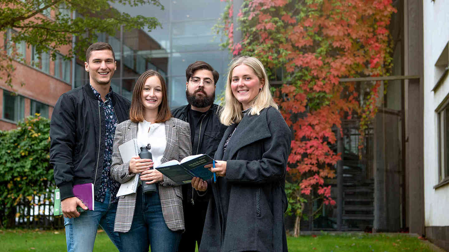 Fyra nöjda alumner utanför campus