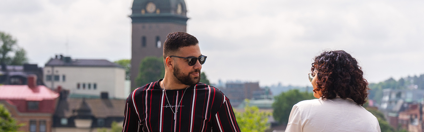 Girl and boy looking at each other with Borås as a view